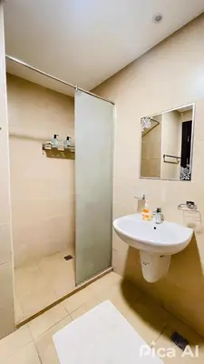 a bathroom with a sink and a glass shower at Amazing Apartment Aldau Heights in Hurghada