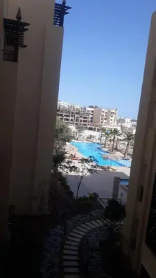a view of the beach from the balcony of a building at Amazing Apartment Aldau Heights in Hurghada