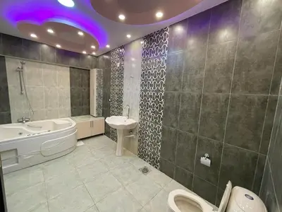 a bathroom with a sink and a tub and a toilet at Al-Kiam Villa Private pool A F in Hurghada