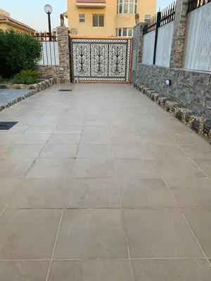 a concrete driveway with a gate and a fence at Al-Kiam Villa Private pool A F in Hurghada
