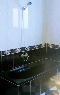 a bathroom with a black tub with a shower at Al-Kiam Villa Private pool A F in Hurghada