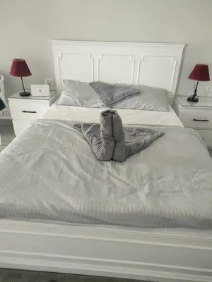 a white bed with a pair of boots on it at Scandic Resort in Hurghada