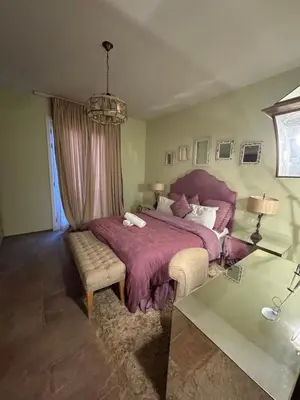 a bedroom with a large bed with a purple bedspread at Abu Tig Marnia El Gouna MB04 in Hurghada