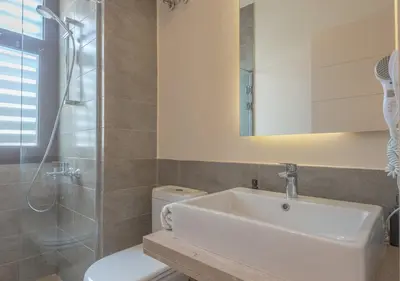 a bathroom with a sink and a shower and a toilet at 4BR Cyan Dream Villa I Pool Lagoon & Sauna in Hurghada