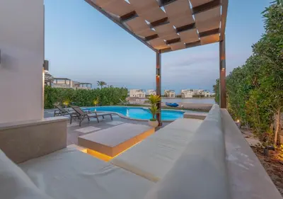 a backyard with a swimming pool and a pergola at 4BR Cyan Dream Villa I Pool Lagoon & Sauna in Hurghada