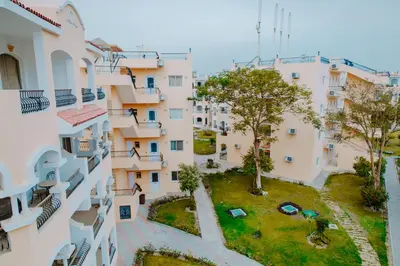 an aerial view of an apartment building with a park at Aton Suites Luxor Resort East Bank Nile View in Luxor