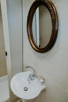 a bathroom with a sink and a mirror at Aton Suites Luxor Resort East Bank Nile View in Luxor