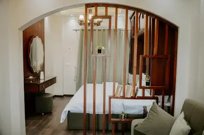 a bedroom with a bed and a large mirror at Aton Suites Luxor Resort East Bank Nile View in Luxor