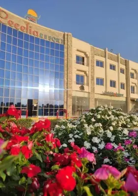 a building with a bunch of flowers in front of it at Steps from Beach & Near Airport Furnteched, Kitchenette, full APT Free WIFI in Hurghada