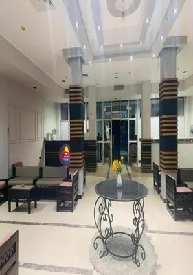 a living room with a table and chairs at Steps from Beach & Near Airport Furnteched, Kitchenette, full APT Free WIFI in Hurghada
