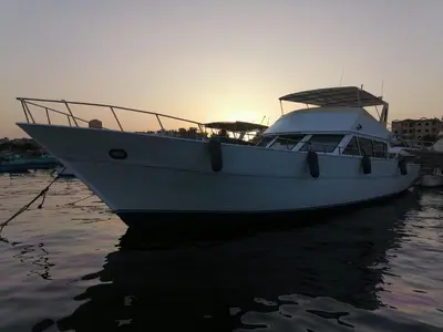 a boat is docked in the water at sunset at Zafeer in Hurghada