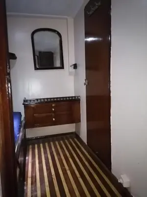 a room with a bed and a mirror and a door at Zafeer in Hurghada