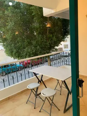 a table and two chairs in front of a fence at Tala 1 in Hurghada