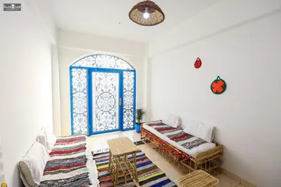 a living room with a couch and a window at Isis Club House in ‘Ezbet Abu Ḥabashi