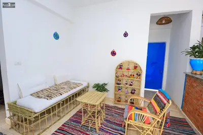 a room with a couch and chairs and a table at Isis Club House in ‘Ezbet Abu Ḥabashi