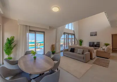 a large living room with a table and chairs at Ancient Sands Gouna 4BR Villa Heated Pool & Lagoon in Hurghada