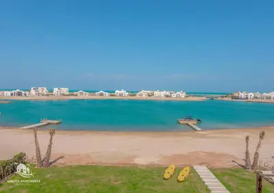 a view of a beach with buildings in the background at Ancient Sands Gouna 4BR Villa Heated Pool & Lagoon in Hurghada