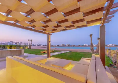 a patio with a couch and a view of the water at Ancient Sands Gouna 4BR Villa Heated Pool & Lagoon in Hurghada