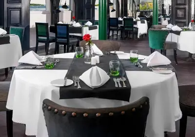 a table in a restaurant with white tables and chairs at Luxor Or Aswan Nile Cruise, Ultra Deluxe Cruises sailing 3, 4, Or 7 Nights in Luxor