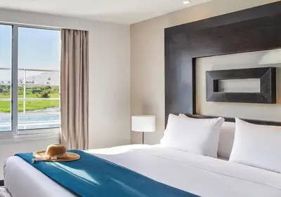 a hotel room with a bed with a hat on it at Luxor Or Aswan Nile Cruise, Ultra Deluxe Cruises sailing 3, 4, Or 7 Nights in Luxor