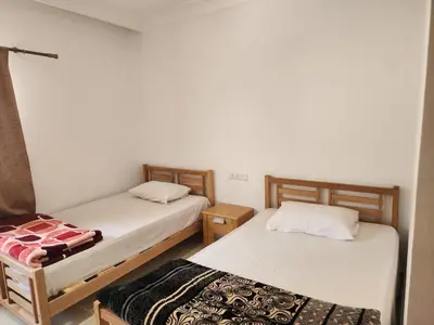 two twin beds in a room withthritisthritisthritisthritisthritisthritisthritisbestosbestos at Doplex for rent in the view 18 in Hurghada