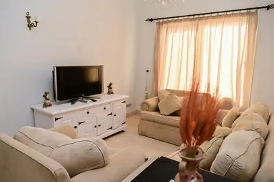 a living room with two couches and a flat screen tv at 6 Bedroom Villa in El-Gouna 38 in Hurghada
