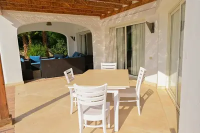 a wooden table and chairs on a patio at 6 Bedroom Villa in El-Gouna 38 in Hurghada