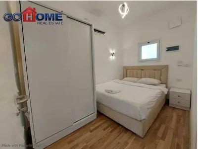 a bedroom with a bed and a large sliding door at 2 Bedroom In Kafr El-Gouna in Hurghada