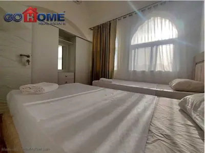 a bedroom with two beds and a window at 2 Bedroom In Kafr El-Gouna in Hurghada