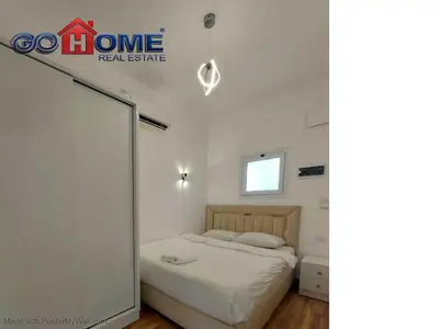 a bedroom with a bed and a mirror at 2 Bedroom In Kafr El-Gouna in Hurghada