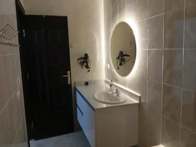 a bathroom with a sink and a mirror at Lägenhet i villa med pool i Hurghada-Magawish in Hurghada