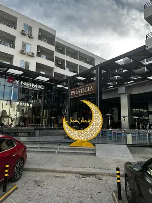 a large building with a yellow moon sculpture in front of it at Wonderful sea view studio in Hurghada