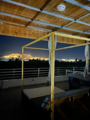 a balcony with a bench on the top of a building at Nile Spirit Sunset in Luxor