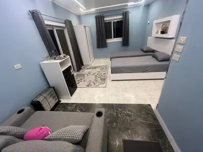 a small room with two beds and a couch at Nile Spirit Sunset in Luxor