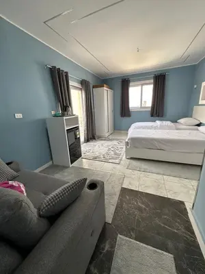 a living room with a bed and a couch at Nile Spirit Sunset in Luxor