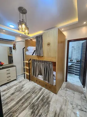 a bedroom with two bunk beds and a chandelier at Hana Stay Hostel in Luxor