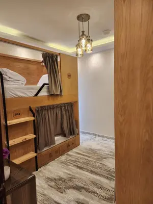 a bedroom with a bunk bed and a chandelier at Hana Stay Hostel in Luxor