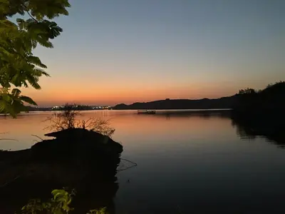 a sunset over a large body of water at Nile View House in Aswan
