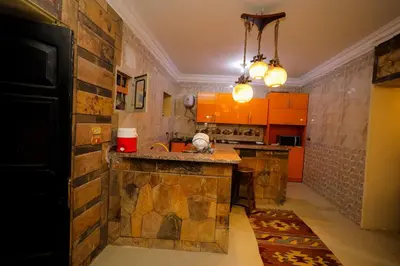a kitchen with orange cabinets and a counter top at Nile View House in Aswan