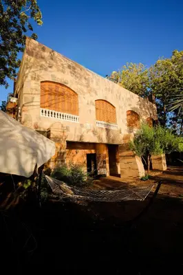 a large stone building with large windows on it at Nile View House in Aswan