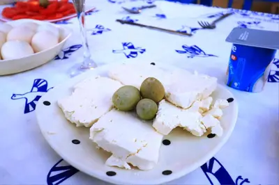 a plate of cheese and olives on a table at Dreams By Mon in Al Karnak