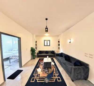 a living room with a couch and a rug at Dreams By Mon in Al Karnak