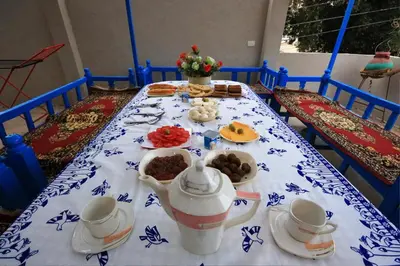 a table with a blue and white table cloth at Dreams By Mon in Al Karnak