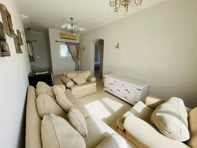 a living room with a couch and a chandelier at Luxury villa in gouna in Hurghada