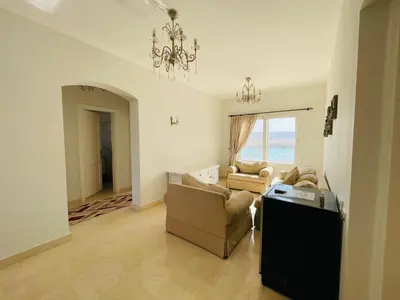 a living room with a couch and a chandelier at Luxury villa in gouna in Hurghada