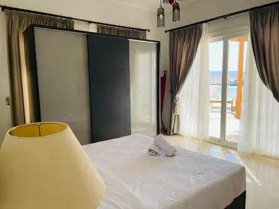 a bedroom with a bed with a purple napkin on it at Luxury villa in gouna in El Gouna
