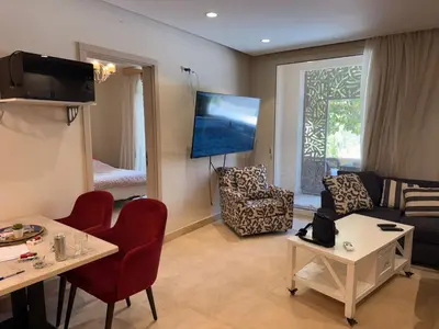 a living room with a couch and a tv at 1 Bedroom In Mangroovy M1 -7B -011 in Hurghada