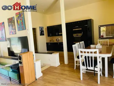a living room with a table and chairs and a kitchen at Studio In Marina El Gouna in Hurghada