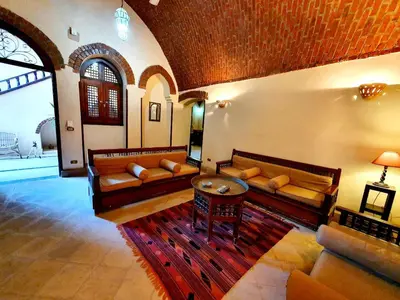 a living room with couches and a table at Villa Rosamund in Luxor