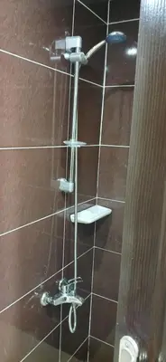 a shower with two faucets on a wall at Florenza Khamsin Hurghada in Hurghada